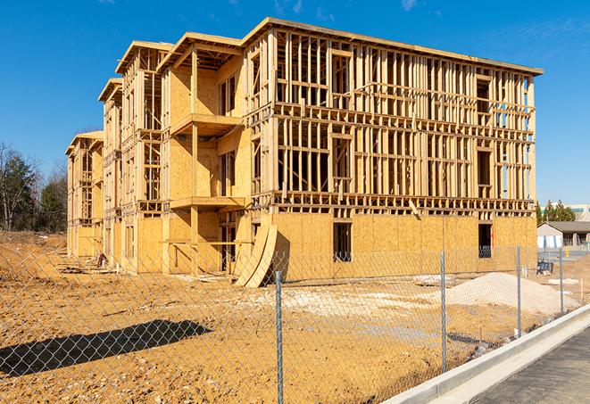 a close-up of temporary chain link fences enclosing a construction site, signaling progress in the project's development in Neptune City, NJ